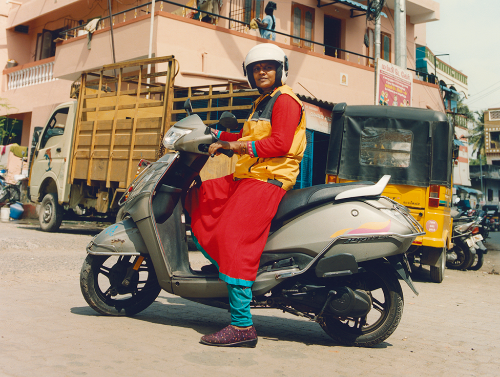 A person sitting on a motorcycle.